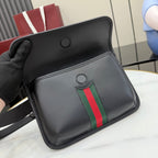 Gucci black crossbody bag with snap top, circular details, and green-red stripe