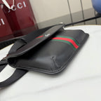 Gucci black crossbody bag with green-red web stripe and adjustable shoulder strap