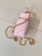 Pink mini Chanel handbag with flap-like top, gold-tone hardware and chain strap