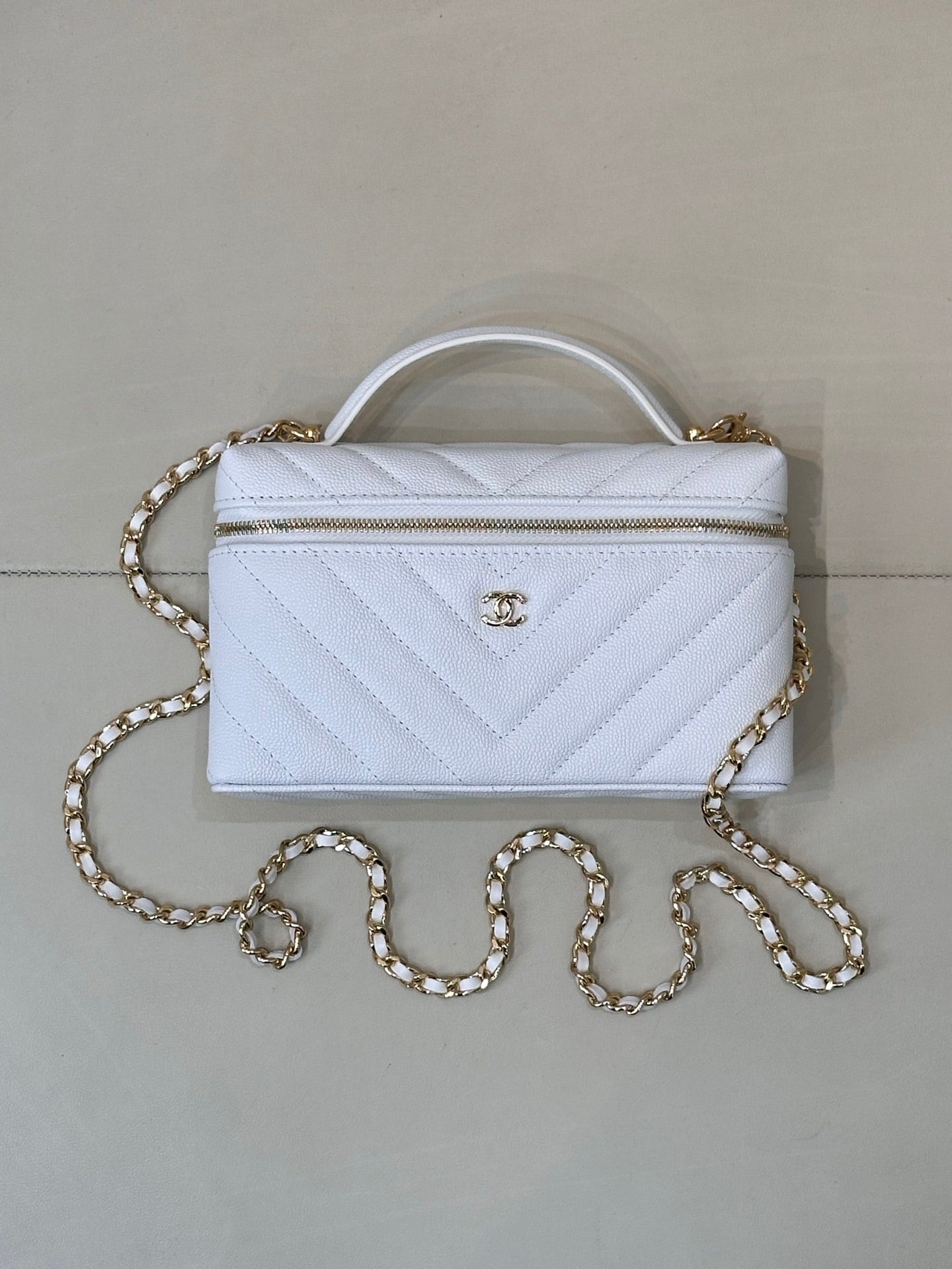 Quilted light blue mini handbag with gold chain and clear top handle
