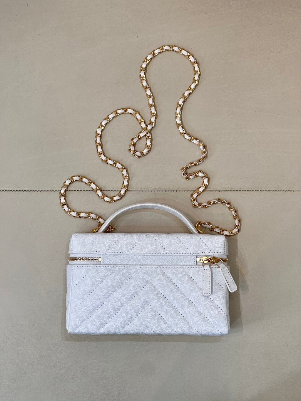 Light blue quilted mini handbag with gold chain strap and top handle