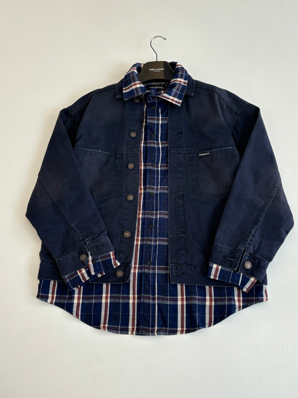 Denim jacket with plaid lining at collar, long sleeves, button-front and chest pockets