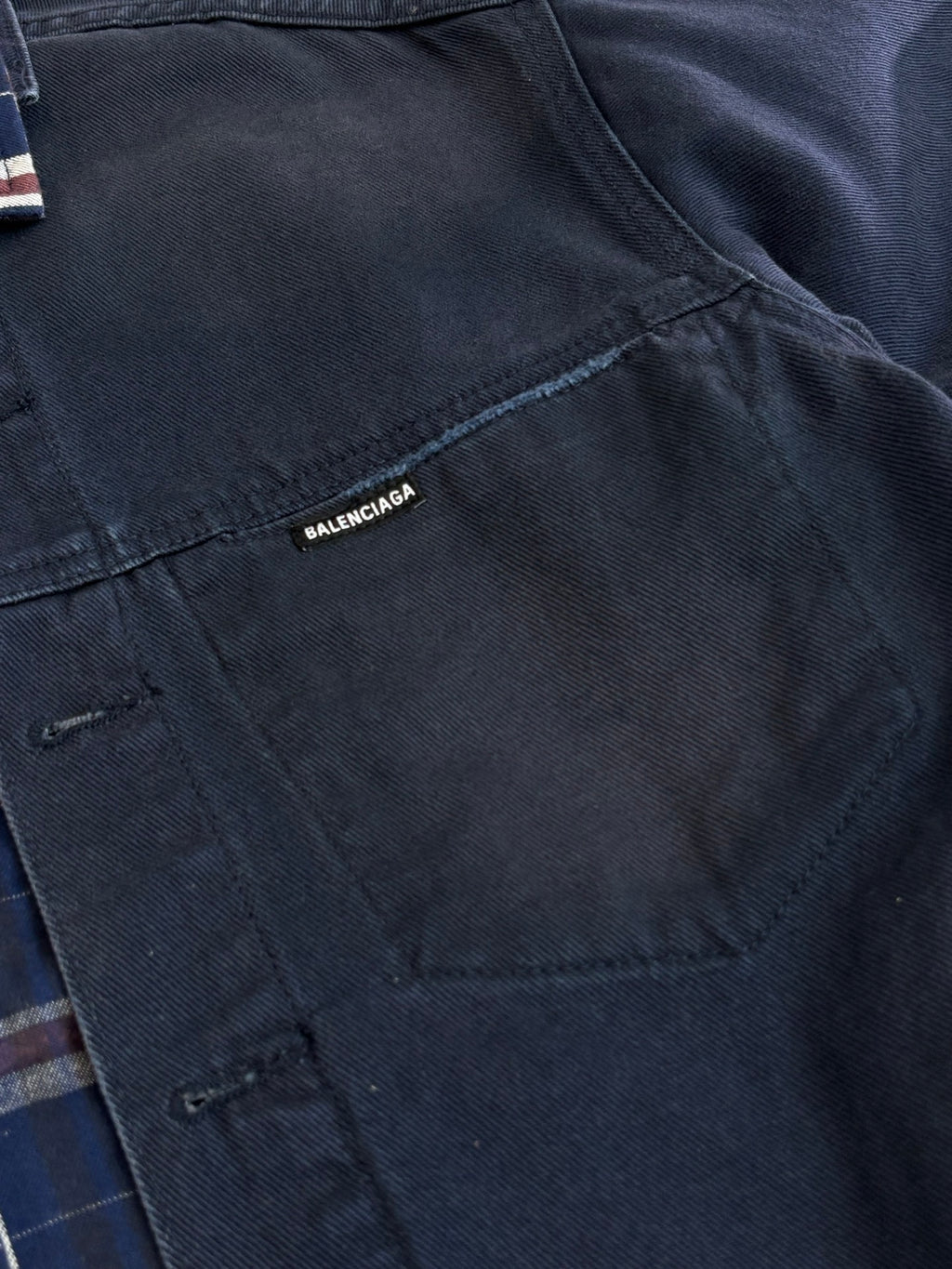 Balenciaga logo tag on dark denim jacket
