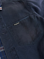 Balenciaga logo tag on dark denim jacket