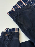 Denim jacket with plaid inner band and metal button at waist