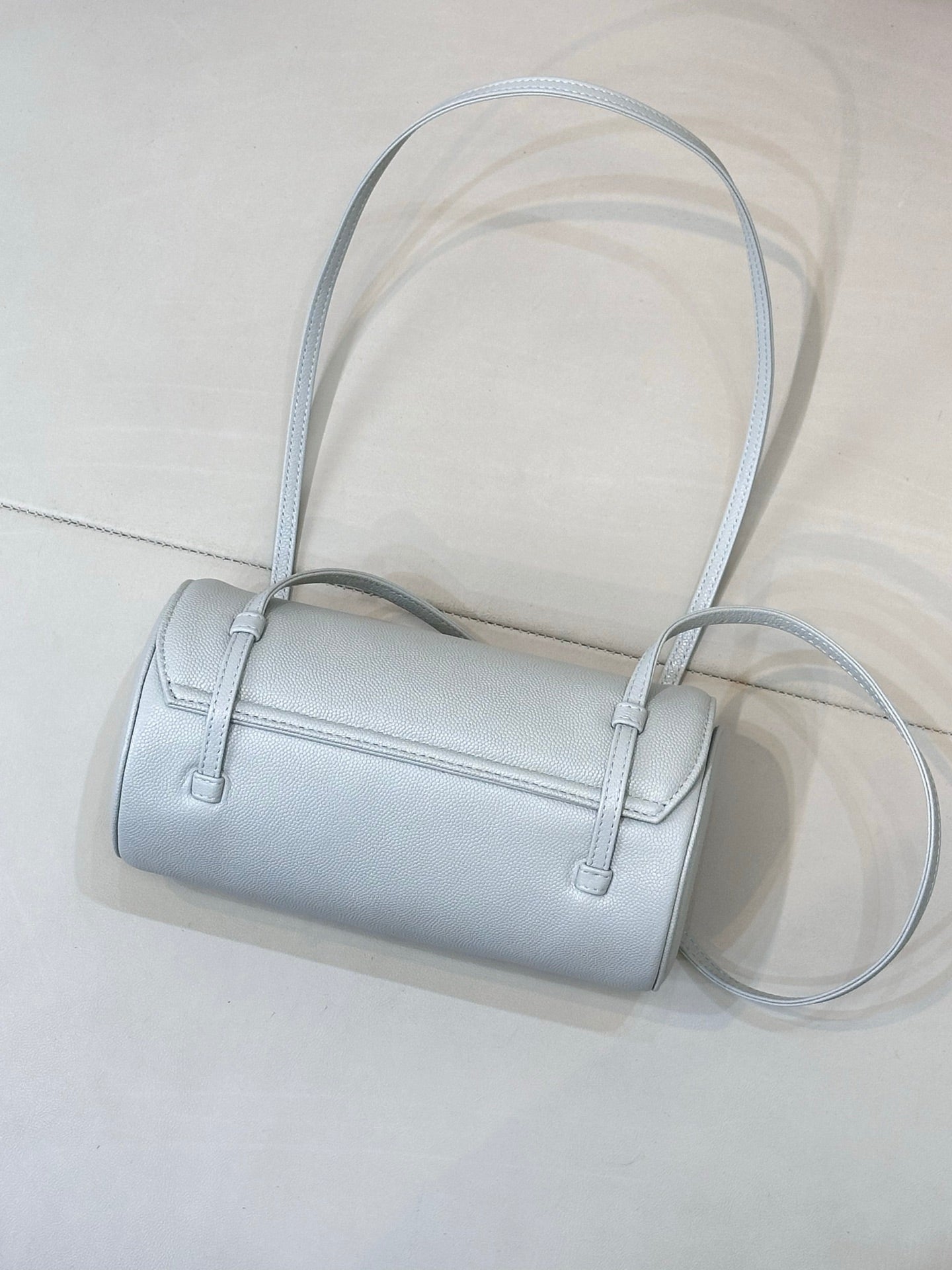 Light blue Chanel handbag with two top straps and long crossbody strap, front logo