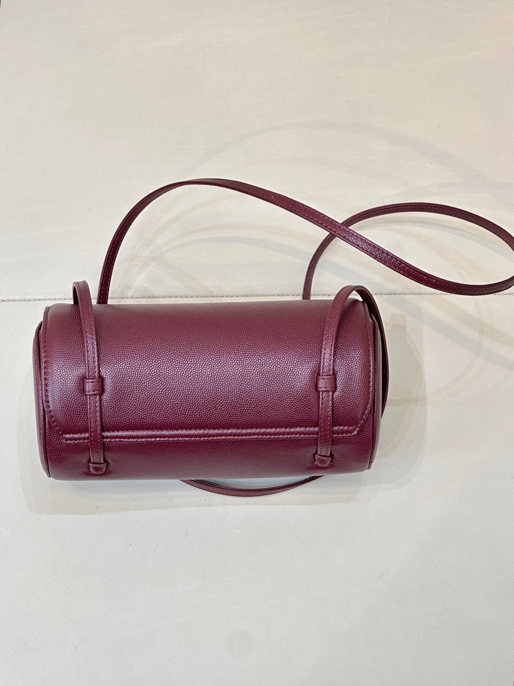 Burgundy leather mini bag with front flap and two vertical strap loops