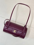 Burgundy leather mini shoulder bag with gold CC emblem and short top handle