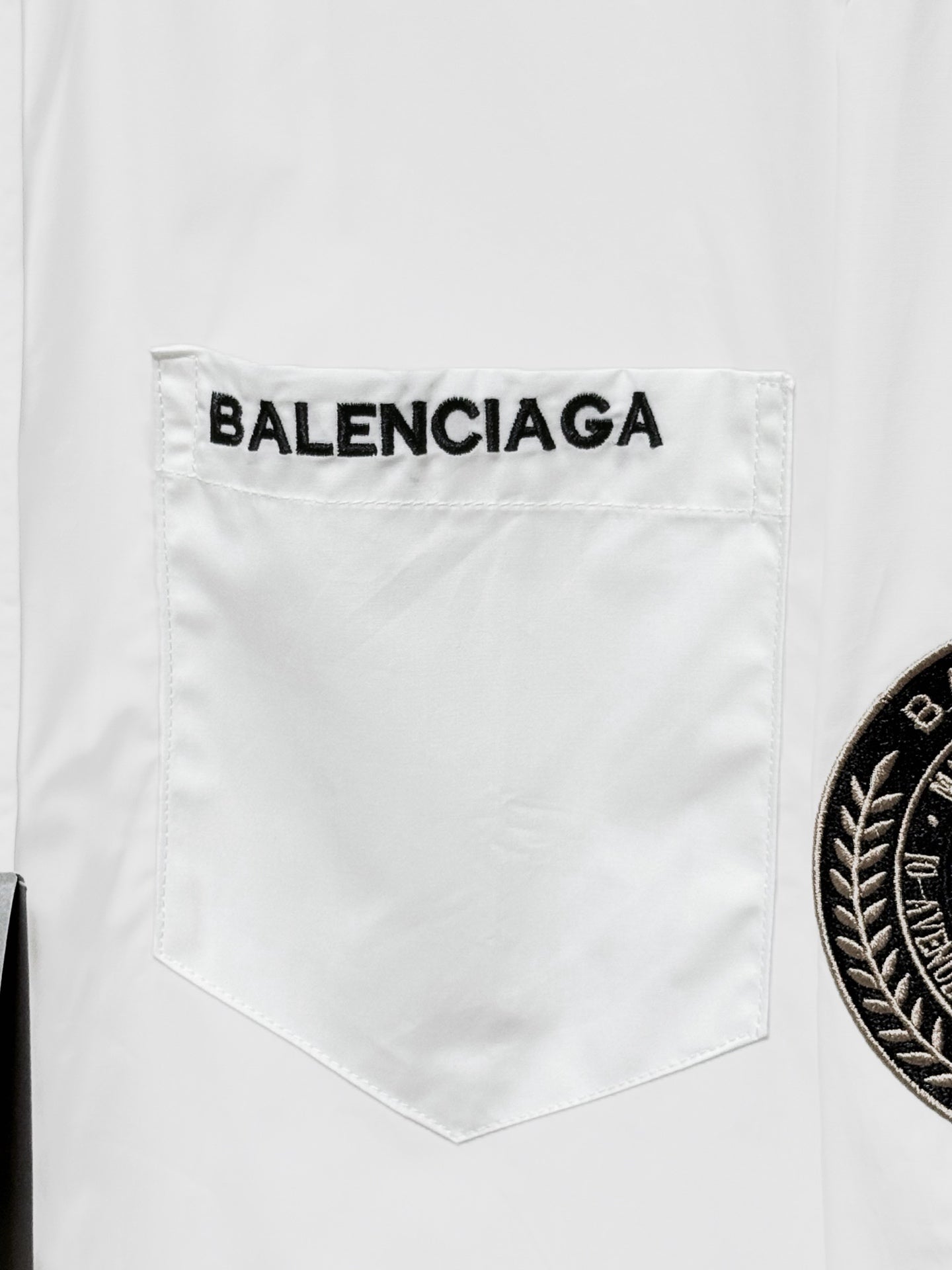 Balenciaga shirt chest pocket, white with printed BALENCIAGA lettering above the pocket.