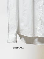Balenciaga long-sleeve button-up shirt hem and cuffs, white fabric, straight hem.