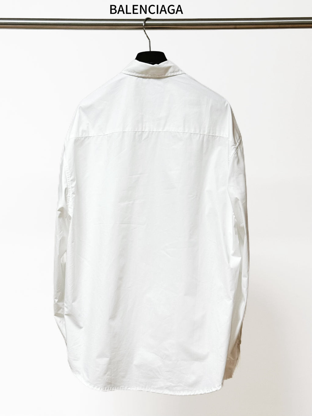 Balenciaga long-sleeve button-up shirt, white, rear view with clean yoke and back seam.
