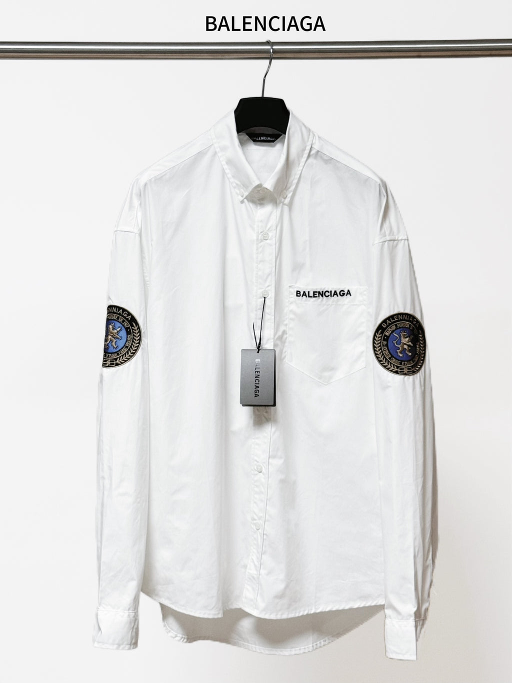 Balenciaga long-sleeve button-up shirt, white, with round sleeve patches and chest logo.