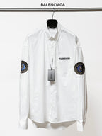 Balenciaga long-sleeve button-up shirt, white, with round sleeve patches and chest logo.