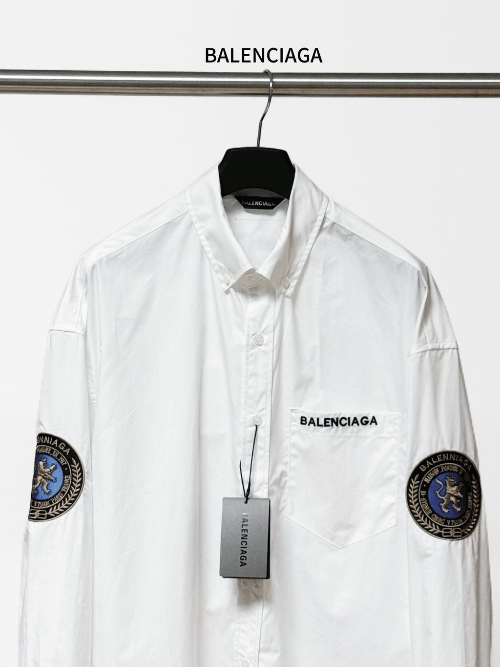 Balenciaga long-sleeve button-up shirt, white, front view with chest logo and sleeve patches.