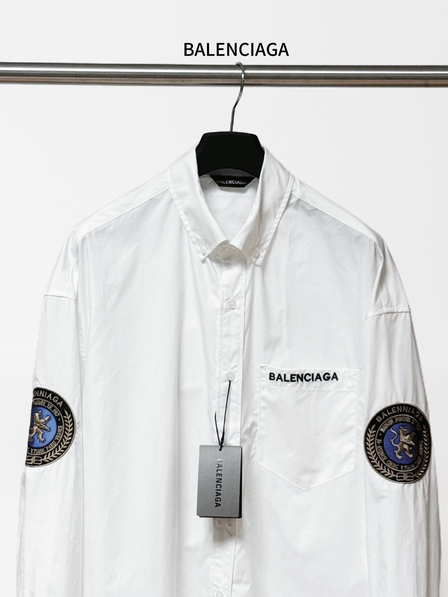 Balenciaga long-sleeve button-up shirt, white, front view with chest logo and sleeve patches.