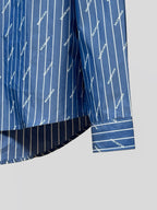 Blue button-up shirt with vertical pinstripe logo print and striped hem detailing