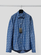 Blue button-up shirt, long sleeves, vertical pinstripe logo print