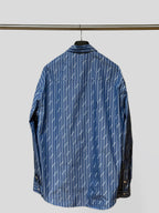 Blue button-up shirt, long sleeves, back view with vertical pinstripe logo print