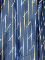 Blue fabric with vertical pinstripe pattern and repeated BALENCIAGA logo