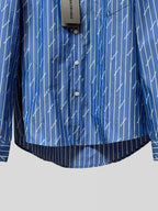 Blue button-up shirt with three-button placket and vertical pinstripe logo print