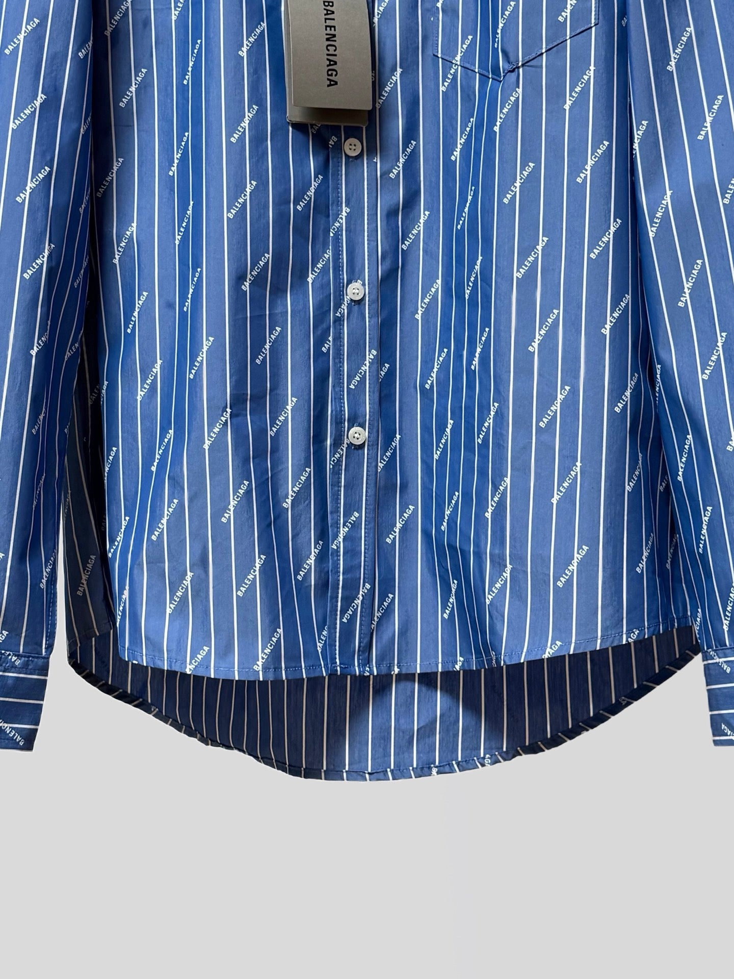 Blue button-up shirt with three-button placket and vertical pinstripe logo print