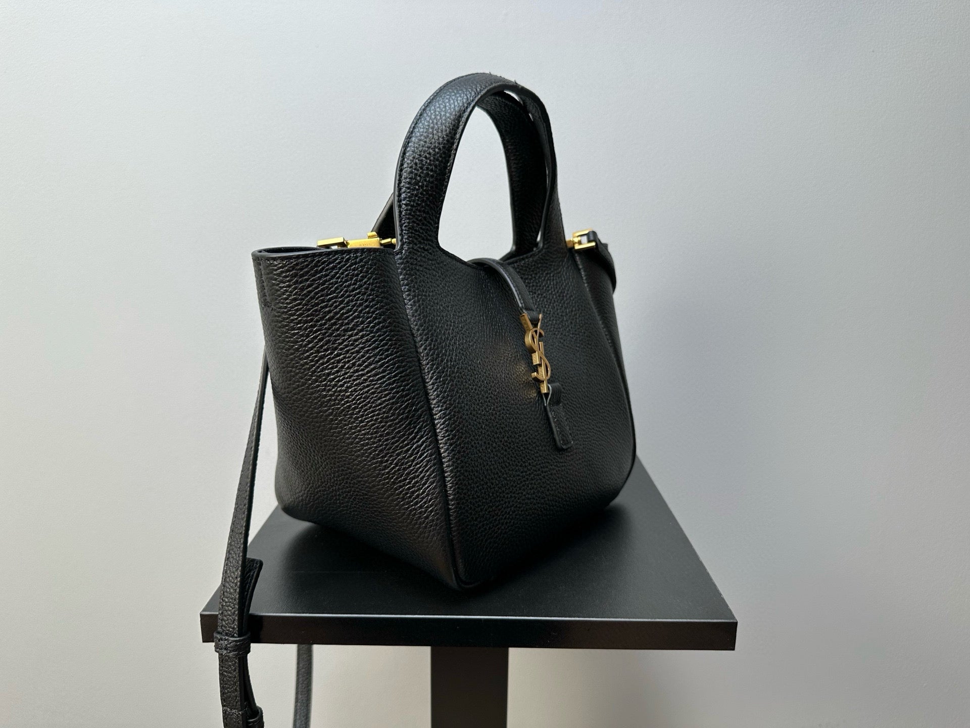 YSL mini tote bag with textured leather finish, top handle, and side hardware accents