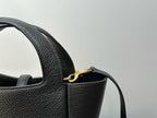 YSL tote bag strap and gold-tone ring hardware with textured leather texture