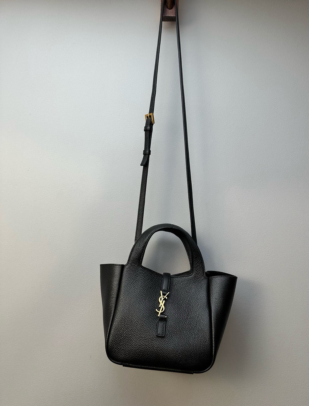YSL tote bag hanging on a shoulder strap with gold-tone hardware