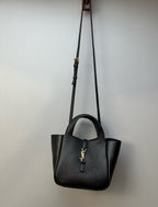YSL tote bag hanging on a shoulder strap with gold-tone hardware