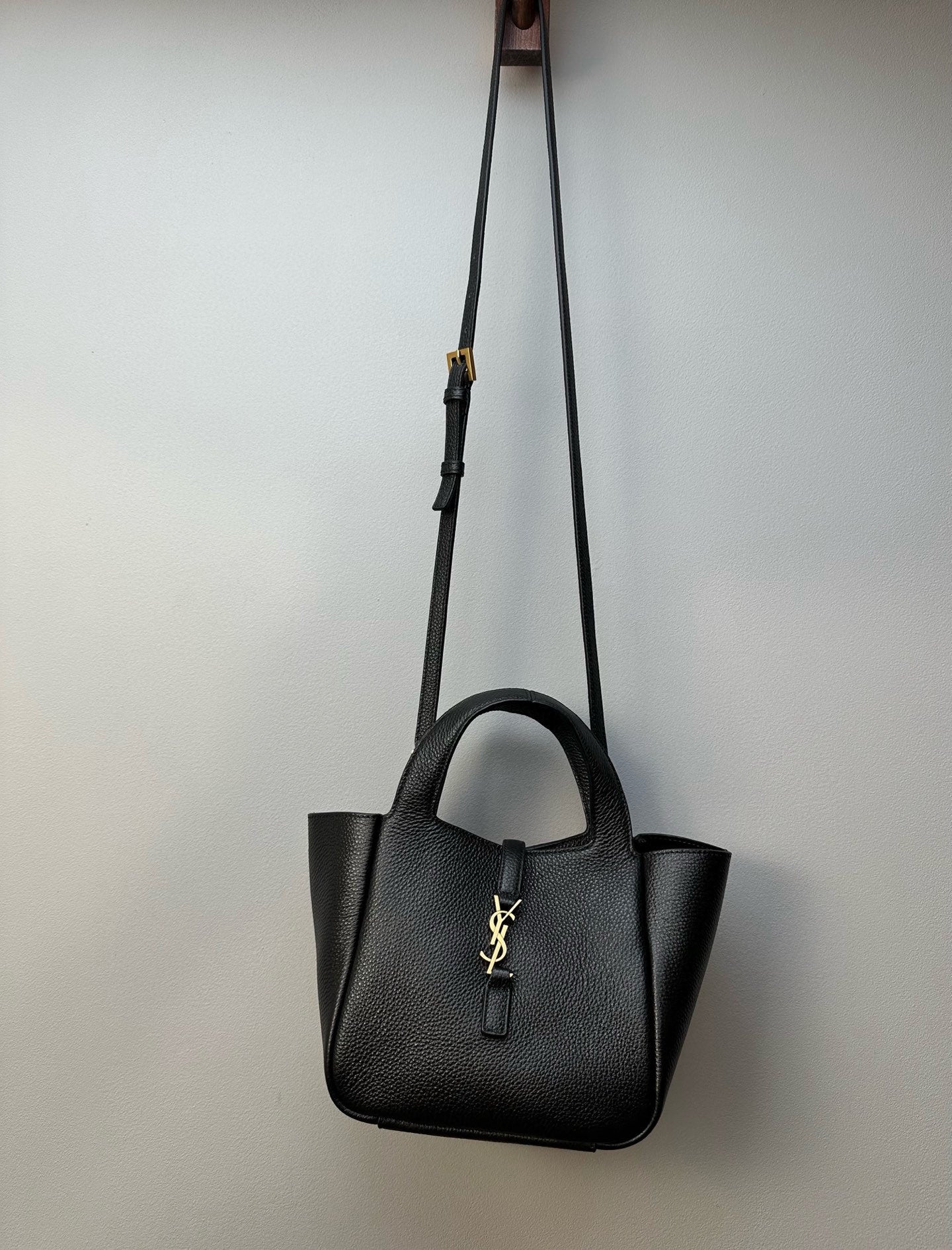 YSL tote bag hanging on a shoulder strap with gold-tone hardware