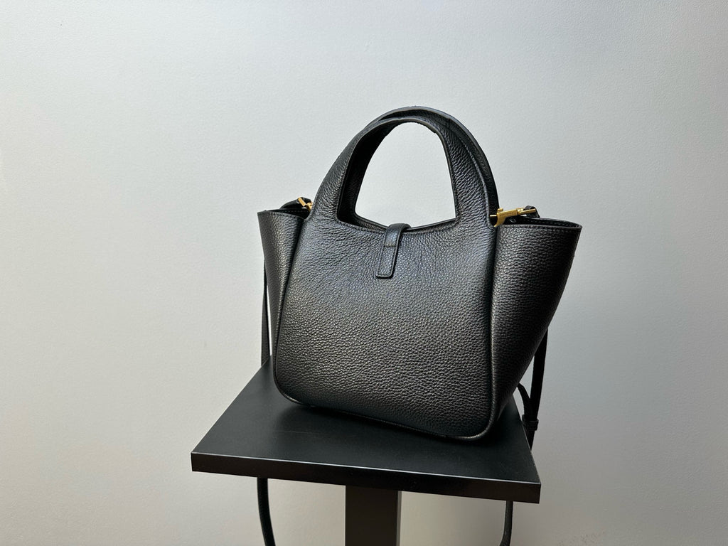 YSL tote bag with structured body, top handles, and gold-tone corner hardware