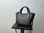 YSL tote bag with structured body, top handles, and gold-tone corner hardware