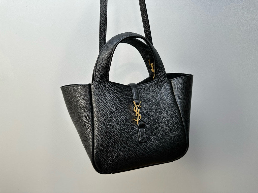 YSL tote bag front view with top handles, structured silhouette, and gold-tone logo charm