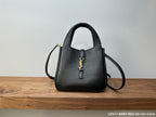 Black leather mini handbag with gold YSL logo, top handle and crossbody strap