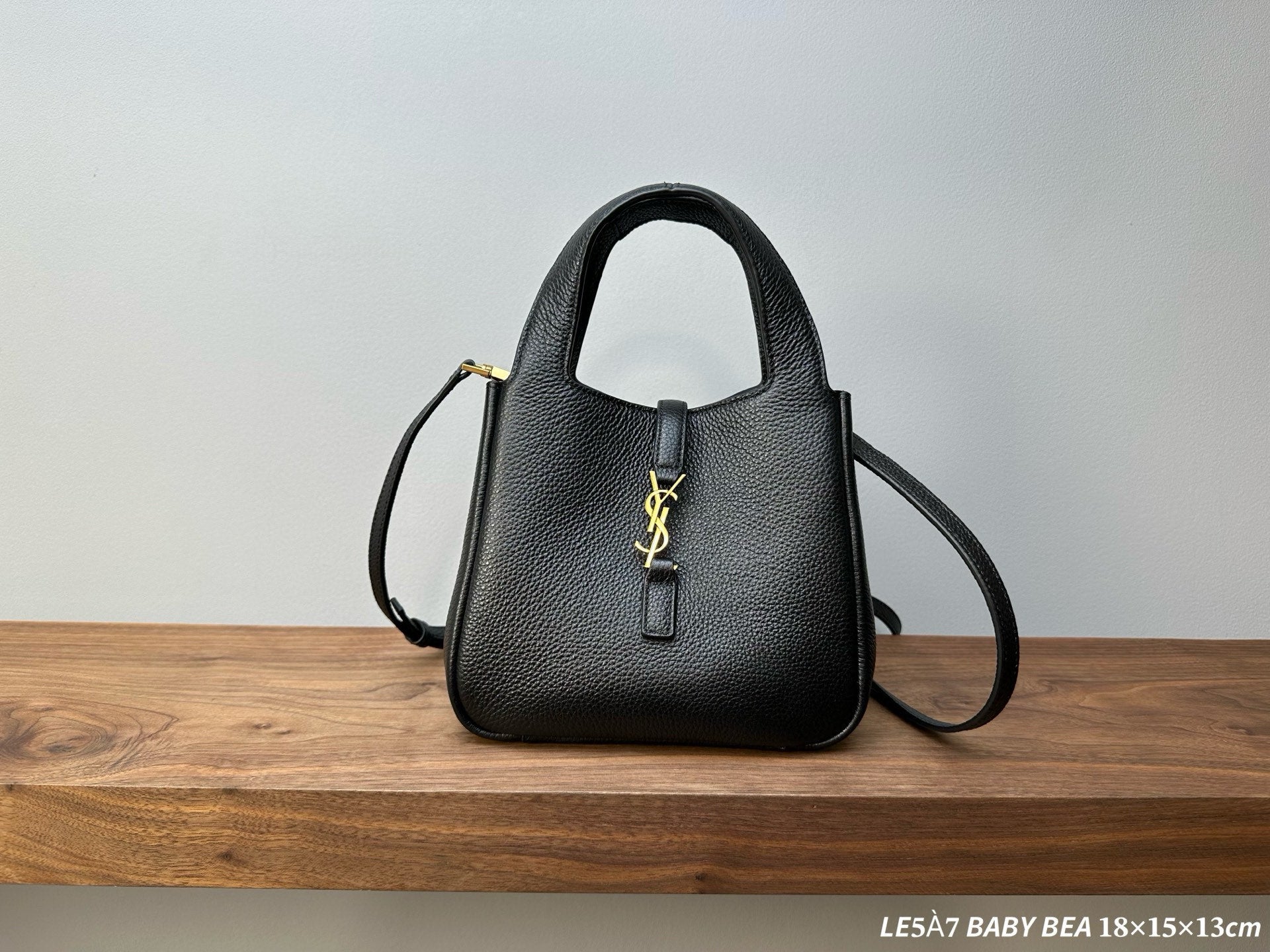 Black leather mini handbag with gold YSL logo, top handle and crossbody strap