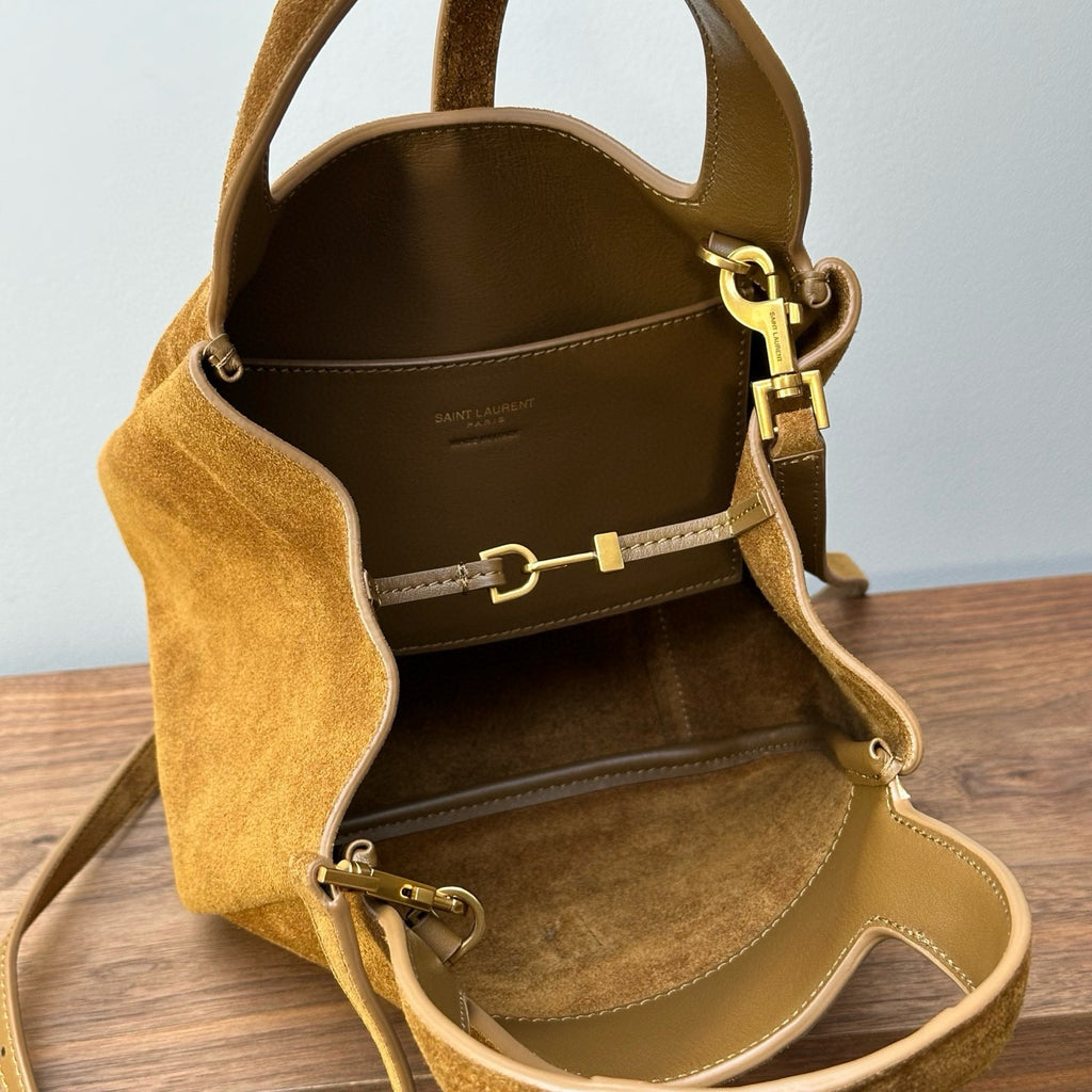 Tan suede tote bag interior with top opening, side snap tabs, and gold buckle hardware