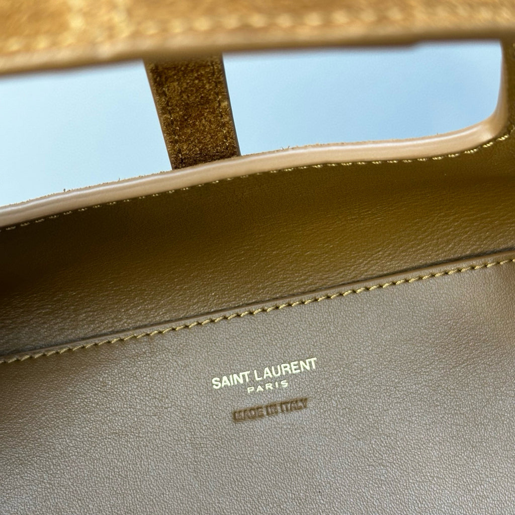 Gold-brown leather bag interior with Saint Laurent Paris branding stamp