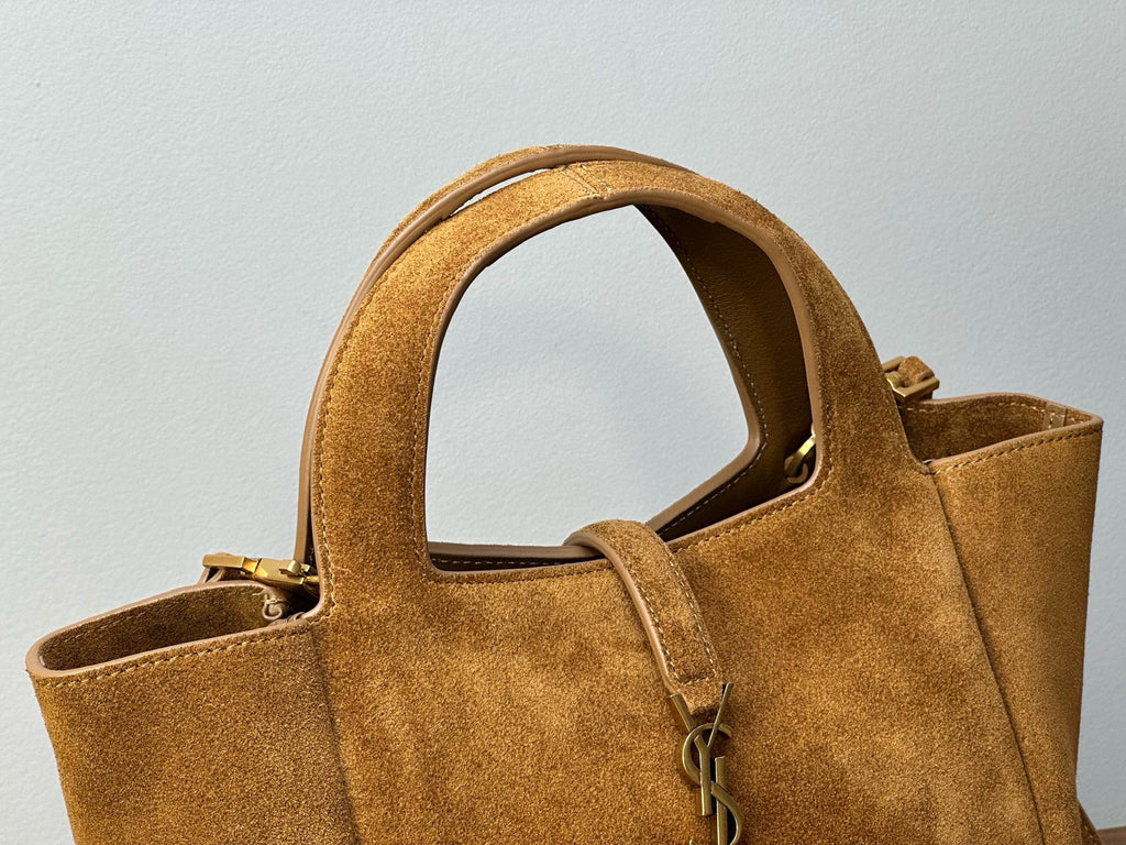 Tan suede tote bag close-up of top handle and shoulder strap with leather trim