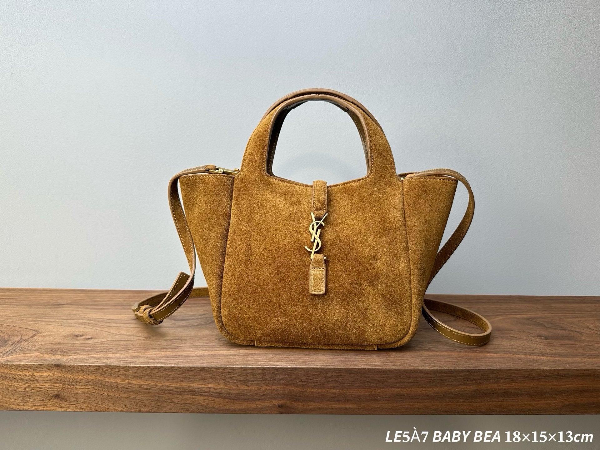Tan suede tote bag with top handles, gold-tone YSL emblem, and zipper pull
