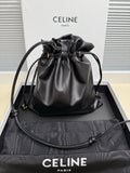 Black leather drawstring bag with gold-toned logo and adjustable shoulder strap