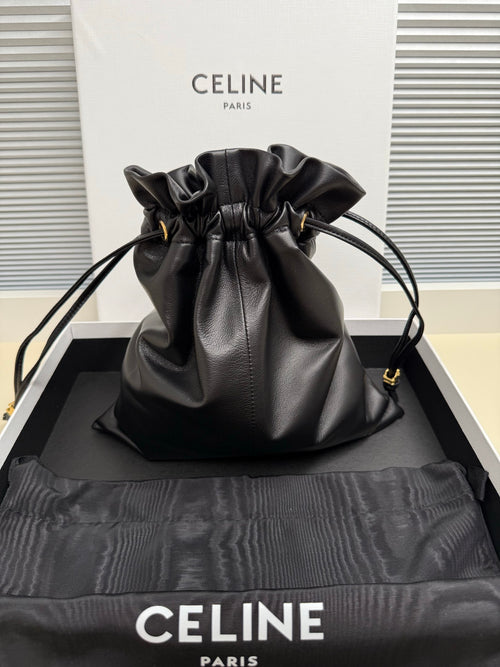 Black leather drawstring bag with ruffled top and gold-toned hardware, shoulder carry