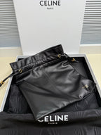 Black leather shoulder bag with drawstring top and gold-toned hardware