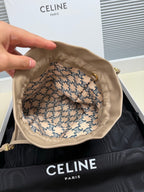 Beige leather drawstring pouch open inside view with patterned lining and braided ties