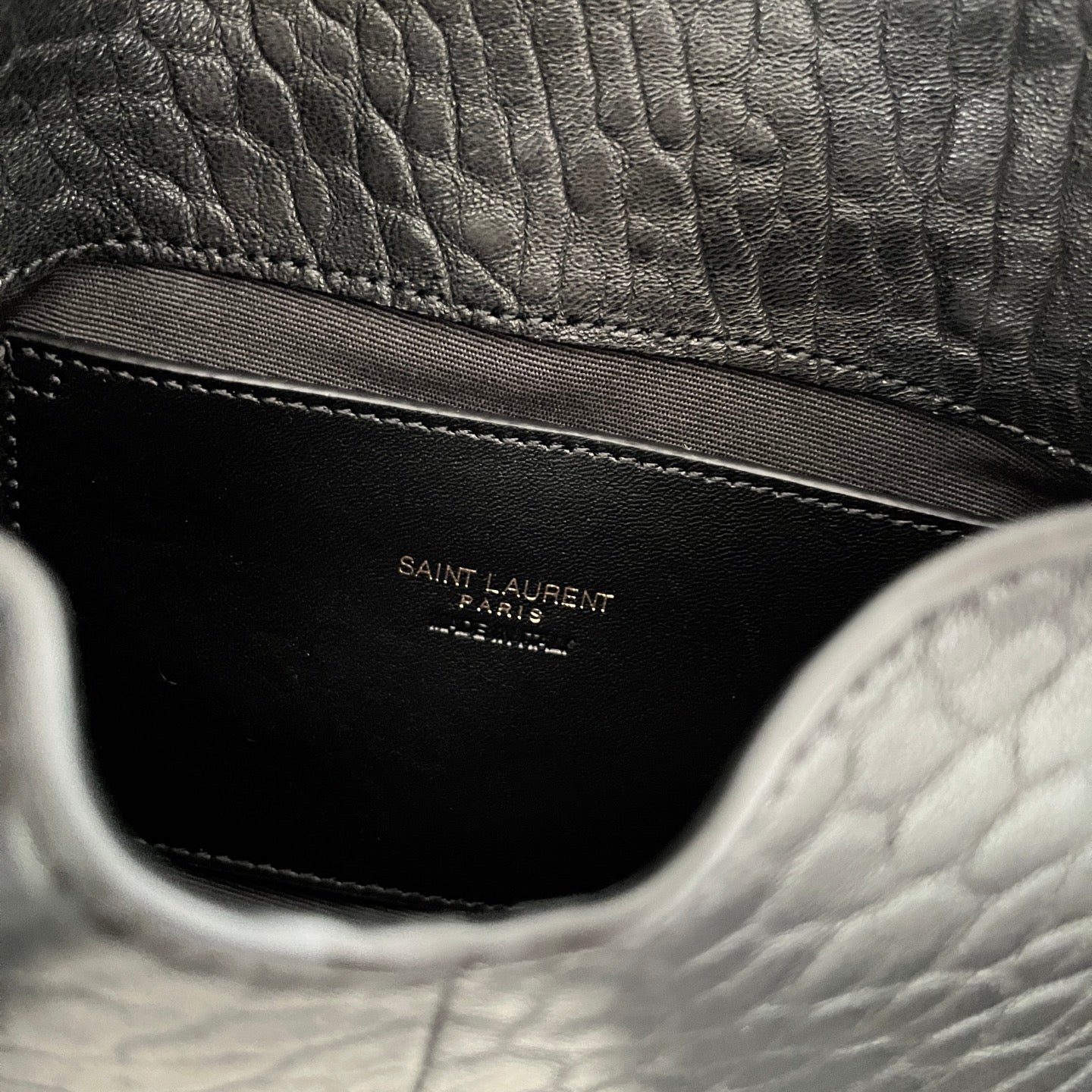 Black interior pocket with YSL logo stamp