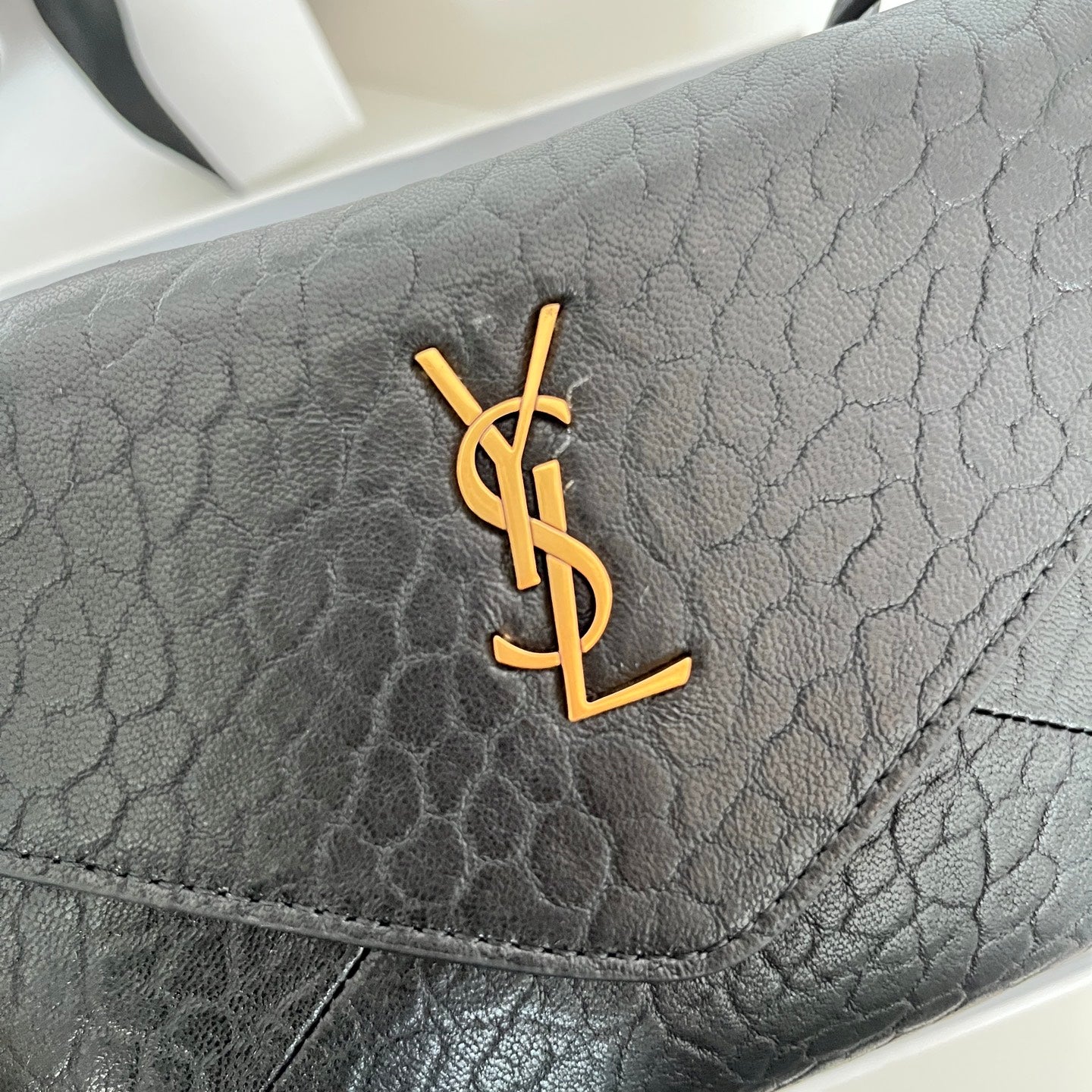 Black textured leather YSL logo on front flap