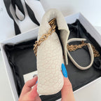 Light off-white textured bag with flap and gold-tone chain handle; open top view