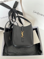 YSL bag, black pebbled leather with gold monogram front and top handles