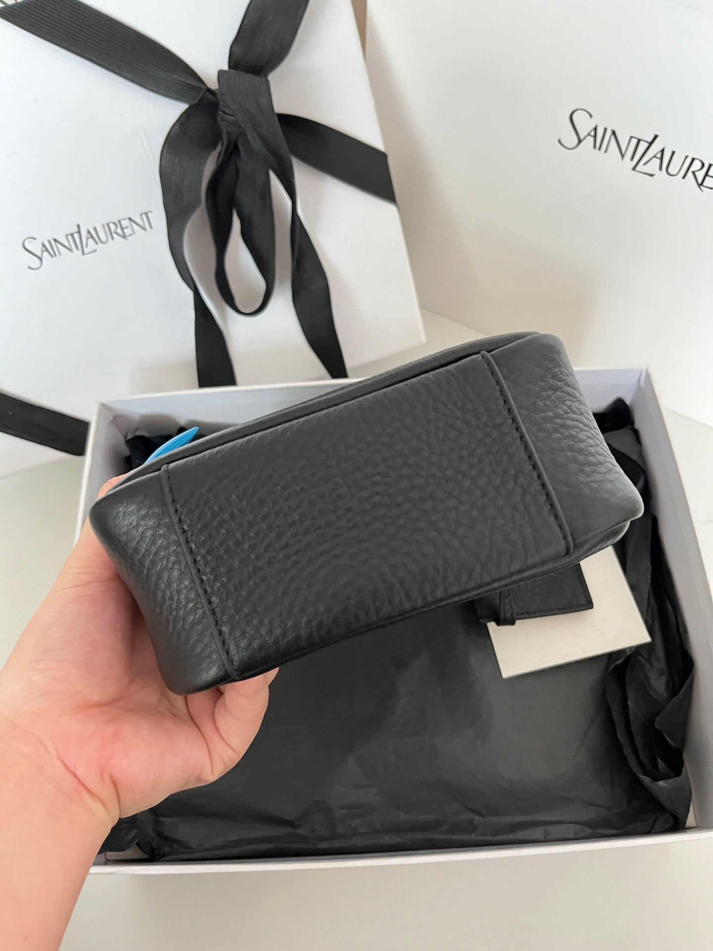 YSL bag, black pebbled leather with flap closure and strap handle