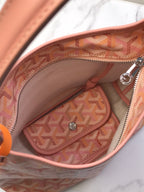 Open pink Goyard-style tote showing canvas lining and interior zip pocket
