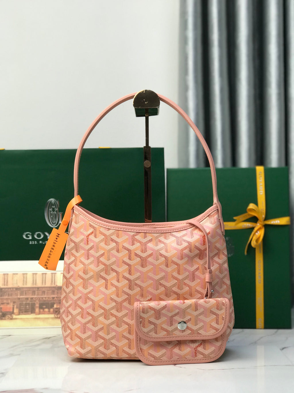 Pink Goyard-style canvas tote bag with top handle and front flap pocket